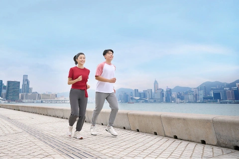 couple running along seaside
