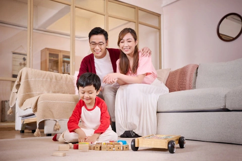 couple looking at kid playing on floor